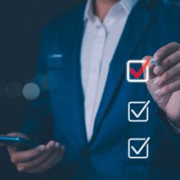 Checklist concept, Businessman mark checkboxes, Survey form, check marks on checklist, filling online form and answering questions. List options business employee security procedures followed office.